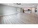 Open floor plan showcases light hardwood floors, recessed lights and seamless flow to the kitchen at 8676 Hillside Dr, Orlando, FL 32810