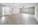 Spacious living room with light hardwood floors, recessed lighting, and view of the entryway at 8676 Hillside Dr, Orlando, FL 32810