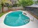 Private backyard pool with lush landscaping and privacy fence at 8676 Hillside Dr, Orlando, FL 32810