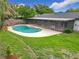 Backyard pool area with a screened-in patio at 8676 Hillside Dr, Orlando, FL 32810