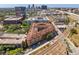 Wide aerial view of complex near railway with city skyline, and dense foliage at 911 N Orange Ave # 440, Orlando, FL 32801