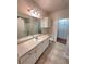 Well-lit bathroom with vanity, sink, toilet, and access to closet/shower offering convenience and modern functionality at 911 N Orange Ave # 440, Orlando, FL 32801