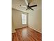 Well-lit bedroom features stylish hardwood floors, a ceiling fan, and a window perfect for relaxing at 911 N Orange Ave # 440, Orlando, FL 32801
