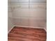 Spacious walk-in closet featuring wood-look flooring and ample shelving for optimal organization and storage solutions at 911 N Orange Ave # 440, Orlando, FL 32801