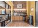 Modern coffee bar featuring granite countertops, mini-fridge, and ample cabinet space, perfect for a quick refreshment at 911 N Orange Ave # 440, Orlando, FL 32801