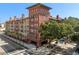Exterior shot of complex with visible street access, lush landscaping, and multi-level balcony access at 911 N Orange Ave # 440, Orlando, FL 32801