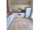 Efficient kitchen featuring white cabinets, matching appliances, and tiled flooring, offering a clean and functional space at 911 N Orange Ave # 440, Orlando, FL 32801
