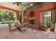 Charming outdoor patio featuring comfortable seating, a fireplace, and views of lush landscaping at 911 N Orange Ave # 440, Orlando, FL 32801