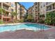 Beautiful in-ground pool area in the center of the complex, surrounded by tropical plants and lounging space at 911 N Orange Ave # 440, Orlando, FL 32801