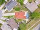 Overhead shot of a single-Gathering home boasting a private, screened-in pool and brick-paved patio, surrounded by manicured landscaping at 10360 Crystal Point Dr, Orlando, FL 32825