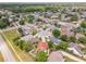 Wide aerial of a residential neighborhood with many mature trees and this home features an terracotta colored roof at 10360 Crystal Point Dr, Orlando, FL 32825
