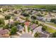 An aerial view of a neighborhood highlighting a single Gathering home with a terracotta roof on a large landscaped lot at 10360 Crystal Point Dr, Orlando, FL 32825