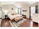 Inviting bedroom with vaulted ceiling, a king bed, and a bench at 10360 Crystal Point Dr, Orlando, FL 32825