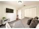 Cozy bedroom with a comfortable bed, mounted TV, and closet for ample storage space at 10360 Crystal Point Dr, Orlando, FL 32825