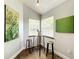 Bright breakfast nook featuring a round table, two stools, and natural light from two windows at 10360 Crystal Point Dr, Orlando, FL 32825