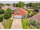 Aerial view of charming single-story home with a well-maintained lawn and a red roof at 10360 Crystal Point Dr, Orlando, FL 32825