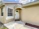 Close-up of a charming front entrance, decorative door, and manicured landscaping detail at 10360 Crystal Point Dr, Orlando, FL 32825