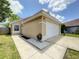 Inviting single-story home with a two-car garage, manicured lawn, and decorative rock features at 10360 Crystal Point Dr, Orlando, FL 32825