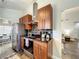 Galley kitchen featuring stainless steel appliances, wood cabinetry, and views of the dining area at 10360 Crystal Point Dr, Orlando, FL 32825