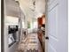 Galley kitchen features stainless steel refrigerator and views of the bar and living room at 10360 Crystal Point Dr, Orlando, FL 32825