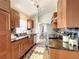 Galley kitchen with granite countertops, stylish backsplash, and stainless steel appliances at 10360 Crystal Point Dr, Orlando, FL 32825