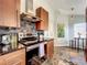 Galley kitchen features modern range hood, decorative tile backsplash, and bar seating at 10360 Crystal Point Dr, Orlando, FL 32825