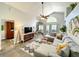 Comfortable living room with high ceilings, modern decor, and an open layout to the kitchen area at 10360 Crystal Point Dr, Orlando, FL 32825