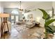 Bright living room with high ceilings, neutral decor, comfortable sectional sofa, and outdoor access at 10360 Crystal Point Dr, Orlando, FL 32825