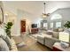 Spacious living room featuring slate floors, a vaulted ceiling and comfortable seating at 10360 Crystal Point Dr, Orlando, FL 32825
