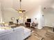 Well-lit living room with slate flooring, vaulted ceiling, and neutral-toned furnishings at 10360 Crystal Point Dr, Orlando, FL 32825