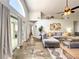 Bright and airy living room with modern decor, vaulted ceiling, and sliding glass doors at 10360 Crystal Point Dr, Orlando, FL 32825