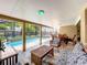 View of the screened-in patio featuring a pool, spa, and comfortable outdoor furniture at 10360 Crystal Point Dr, Orlando, FL 32825