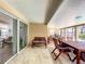 Covered patio with dining area and a sliding glass door leading to the home's interior at 10360 Crystal Point Dr, Orlando, FL 32825