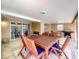 Covered patio area with outdoor dining and seating area, complete with a barbecue grill at 10360 Crystal Point Dr, Orlando, FL 32825