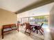 Covered patio area with dining table, barbecue grill, seating, and access to the pool at 10360 Crystal Point Dr, Orlando, FL 32825