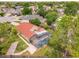 Aerial view of the screened-in pool area with brick pavers, well-kept lawn, and a red-tiled roof at 10360 Crystal Point Dr, Orlando, FL 32825