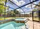 The screened-in pool includes a spa at 10360 Crystal Point Dr, Orlando, FL 32825