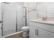 Modern bathroom features a glass-enclosed shower and a white vanity with storage at 11027 Hollow Bay Dr, Winter Garden, FL 34787