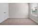 Bedroom with neutral carpet and a window with blinds, next to a white door at 11027 Hollow Bay Dr, Winter Garden, FL 34787