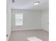 Bright bedroom with neutral carpet and a window with blinds, next to a white door at 11027 Hollow Bay Dr, Winter Garden, FL 34787