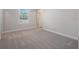 Large bedroom with plush carpeting, natural light, and an ensuite bathroom at 11027 Hollow Bay Dr, Winter Garden, FL 34787