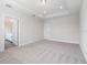 Bedroom with neutral walls, plush carpeting, and an ensuite bathroom at 11027 Hollow Bay Dr, Winter Garden, FL 34787