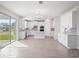 Modern open-concept kitchen boasts white cabinets, tile backsplash and island with breakfast bar at 11027 Hollow Bay Dr, Winter Garden, FL 34787