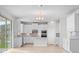 Modern kitchen with white cabinets, tile backsplash, and stainless-steel appliances at 11027 Hollow Bay Dr, Winter Garden, FL 34787
