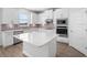 Stylish kitchen with a central island, stainless steel appliances, and sleek, white cabinetry at 11027 Hollow Bay Dr, Winter Garden, FL 34787