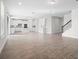 Bright and spacious living area showcases modern white kitchen and staircase at 11027 Hollow Bay Dr, Winter Garden, FL 34787