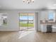 Bright living space with sliding glass doors opening to a scenic view and modern lighting at 11027 Hollow Bay Dr, Winter Garden, FL 34787