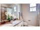 This bathroom offers a double vanity, a toilet, marble countertops, and a tiled shower behind glass doors at 11045 Hollow Bay Dr, Winter Garden, FL 34787