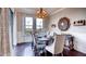 Inviting dining room featuring hardwood floors, elegant chandelier, and a sliding door to outside at 11045 Hollow Bay Dr, Winter Garden, FL 34787