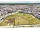 An aerial view showcases a Gathering-friendly neighborhood with a central green space for outdoor recreation at 11288 Listening Dr, Orlando, FL 32832